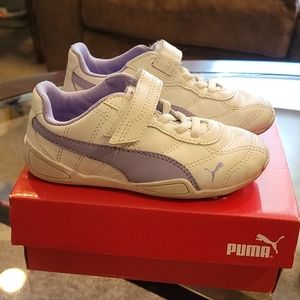 Girls purple and white Puma soccer shoes